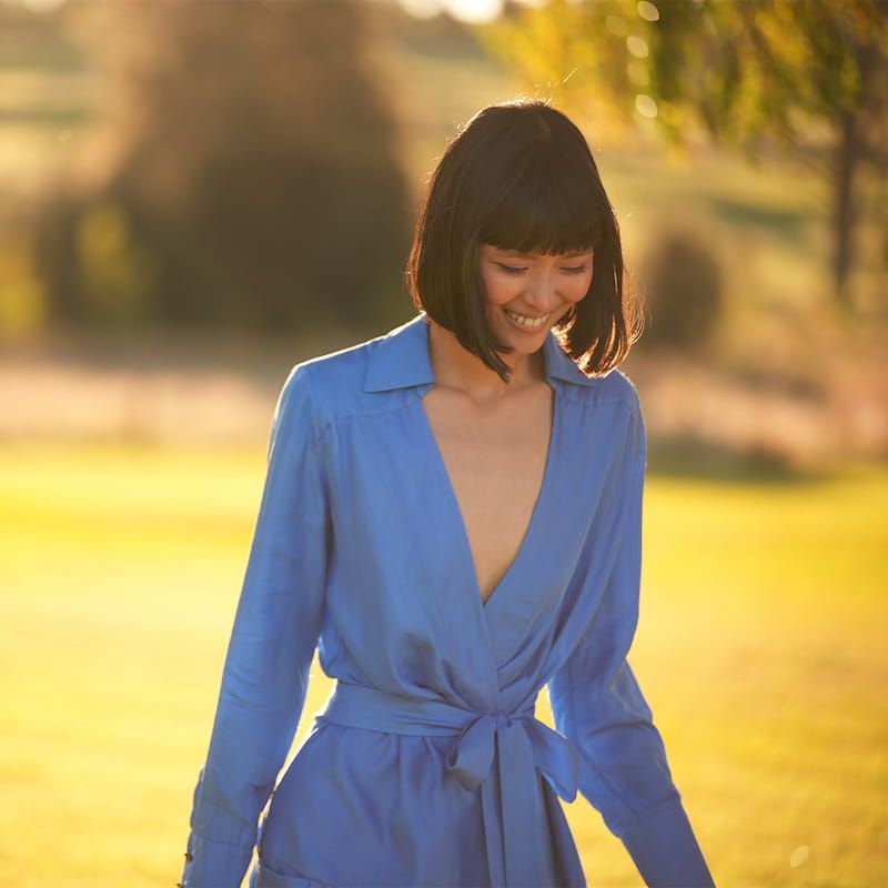 model wearing a blue long sleeve wrap dress