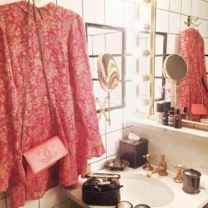 Dress and Chanel bag in designer bathroom 