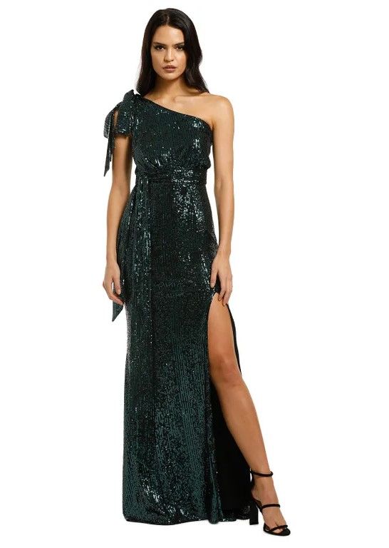Woman wearing a dark green sequin gown by Love Honor